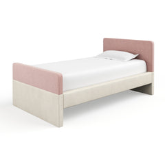 White bed with tall white headboard and rails, minimalist.